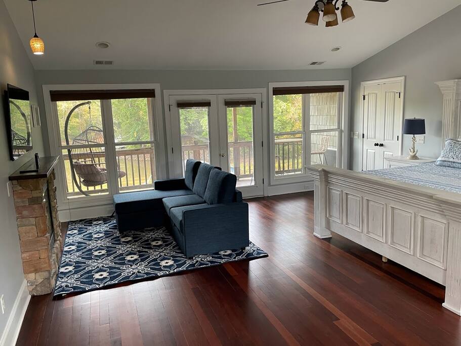 Indulge in this spacious top-level master suite, featuring a private balcony with stunning lake views. It includes an en-suite bathroom, and a unique walk-in closet transformed into a cozy sleeping nook. A sleeper sofa offers added flexibility. Indulge in this spacious top-level master suite, featuring a private balcony with stunning lake views. It includes an en-suite bathroom, and a unique walk-in closet transformed into a cozy sleeping nook. A sleeper sofa offers added flexibility. - Chalet on Lake Wylie, Waterfront w/Beach/Sleeps 16 - Belmont