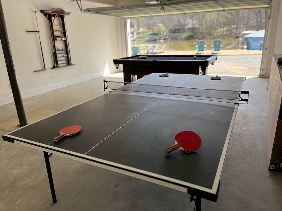 Experience the ultimate game room in our versatile garage. Play pool or ping pong, relax in the corner seating, and open the garage to create an airy, indoor-outdoor space. Enjoy breathtaking lake views and refreshing breezes while you play. Experience the ultimate game room in our versatile garage. Play pool or ping pong, relax in the corner seating, and open the garage to create an airy, indoor-outdoor space. Enjoy breathtaking lake views and refreshing breezes while you play. - Chalet on Lake Wylie, Waterfront w/Beach/Sleeps 16 - Belmont
