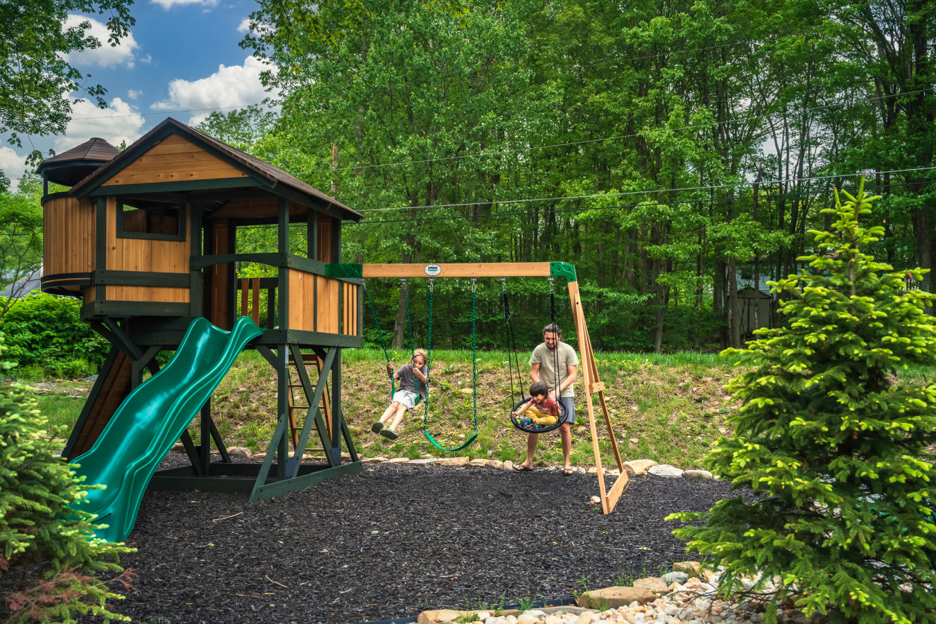 A backyard paradise for the little ones — complete with a slide, swings, and endless fun!