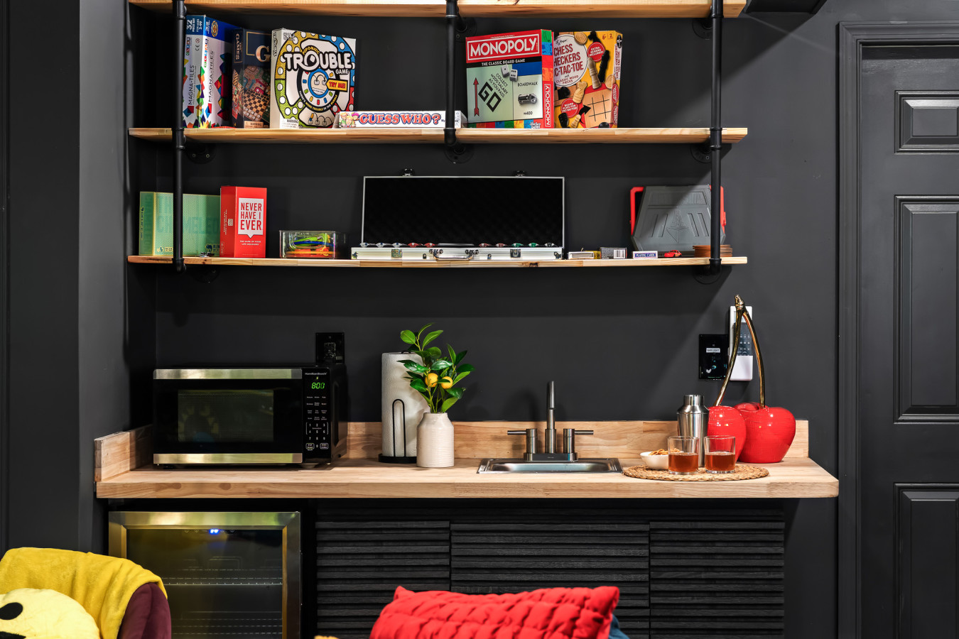 Game night made easy! Our game room features a convenient kitchenette with a sink, microwave, and mini fridge — plus a full wall of board games for endless fun.