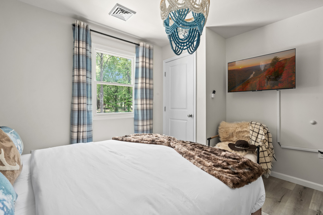 Cozy queen bedroom with a smart TV for your comfort and entertainment.