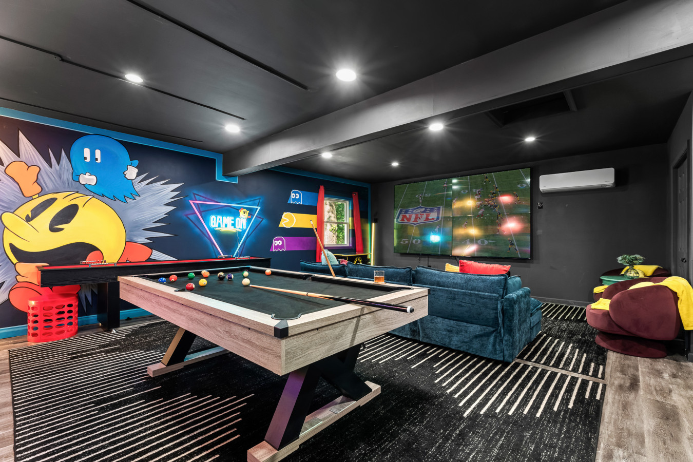Unwind in our fully equipped game room — shoot pool, play foosball, shuffleboard, or table tennis, and enjoy retro arcade fun with our classic Pac-Man machine and electronic darts!