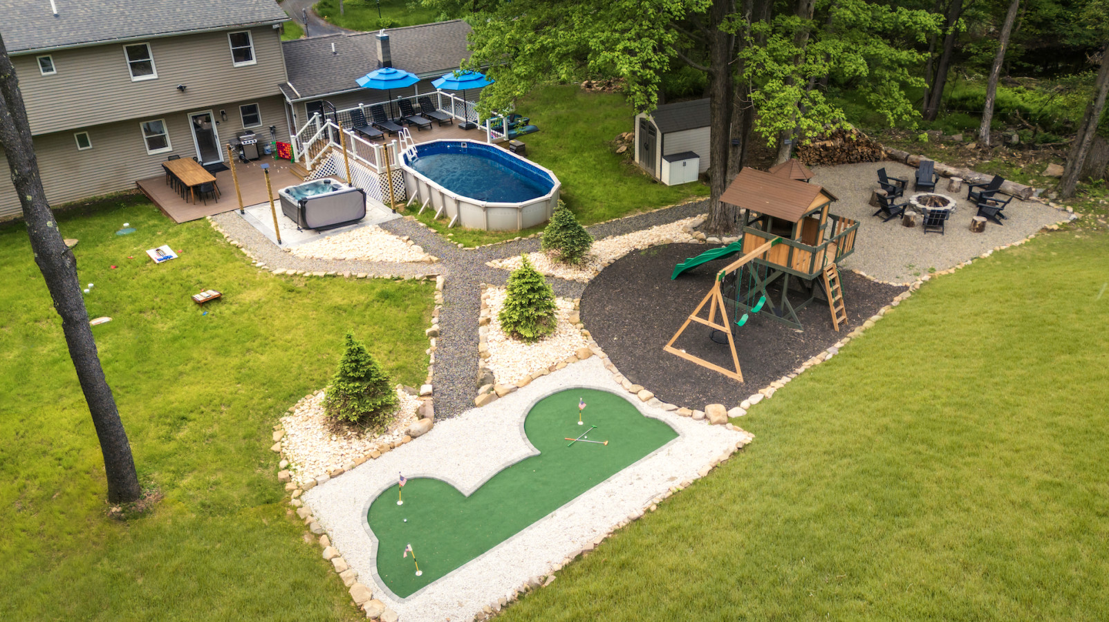 Spend hours of fun in the backyard, featuring our seasonal pool, hot tub, mini golf, outdoor dining area, slide, swing set, and much more!