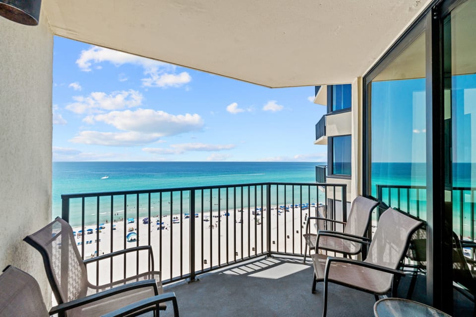 Take in the salty breeze and stunning beach views from your private balcony with comfortable seating.