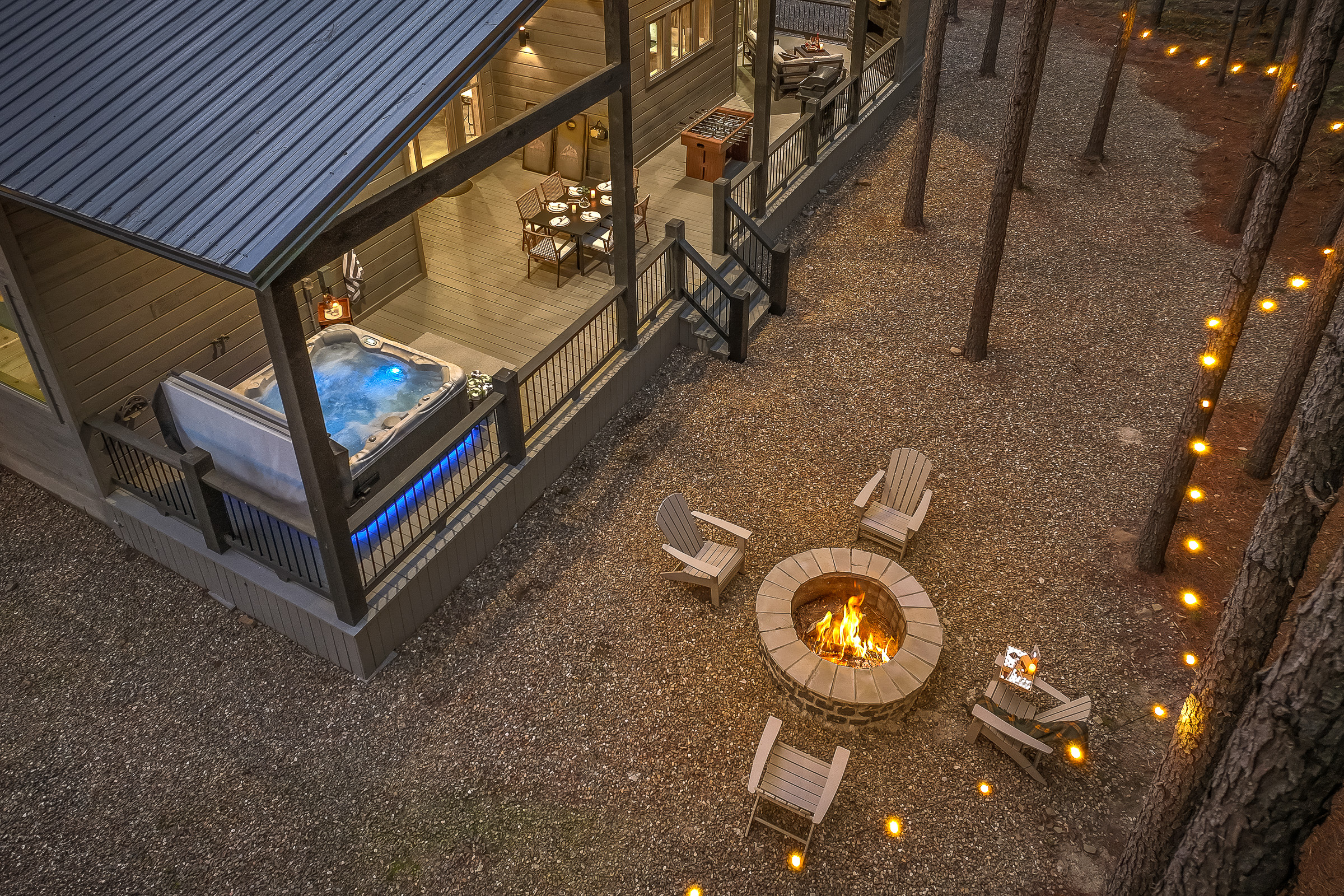 The covered back deck is perfect rain or shine!  Every cabin stay has to play some corn hole around the camp fire!
