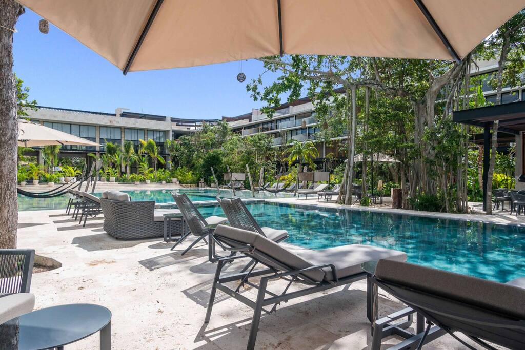 Spacious and majestic pool surrounded by inviting, cozy hammocks – a haven of relaxation.