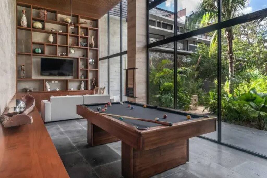 Common areas featuring a billiard table, TV, and cozy chill-out space.