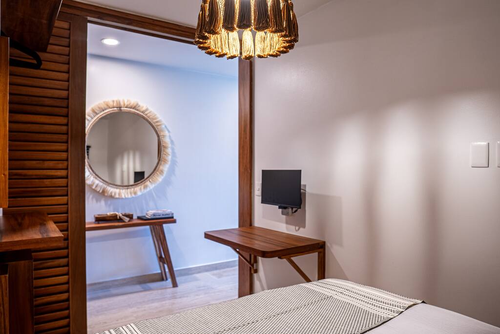 Queen-size bed and a sleek home office desk equipped with an HD monitor for productivity.