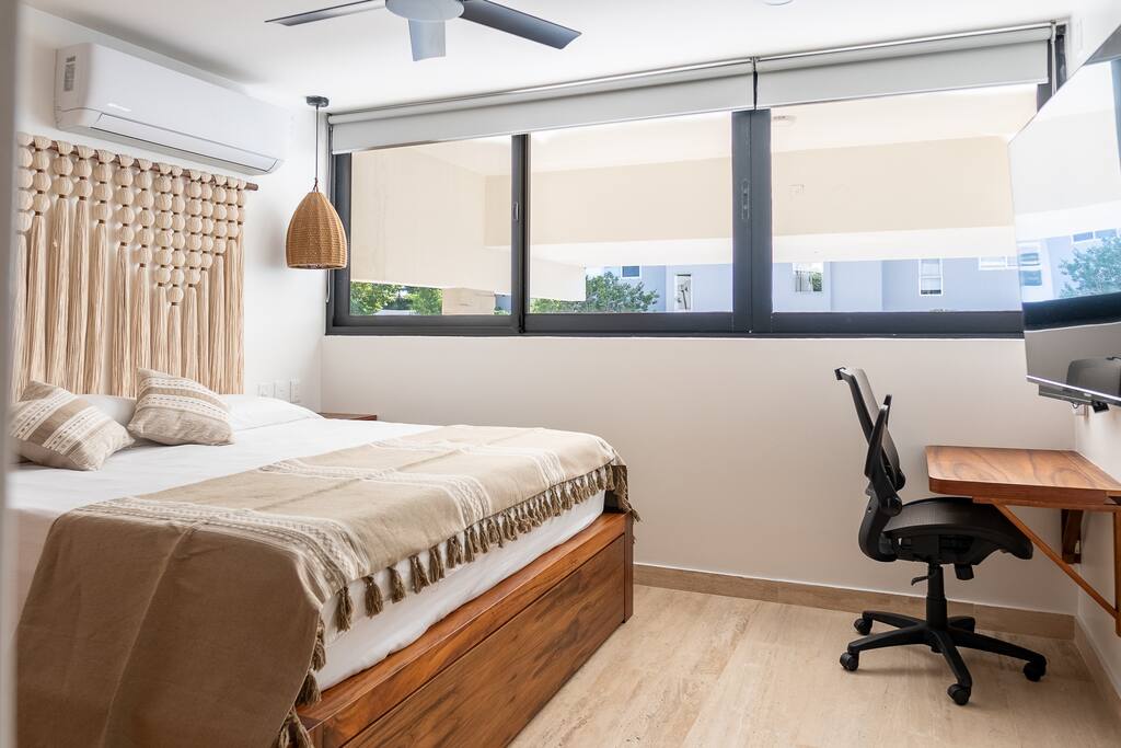 Spacious king-size bed and a sleek home office desk, complete with a high-definition monitor for your comfort and productivity