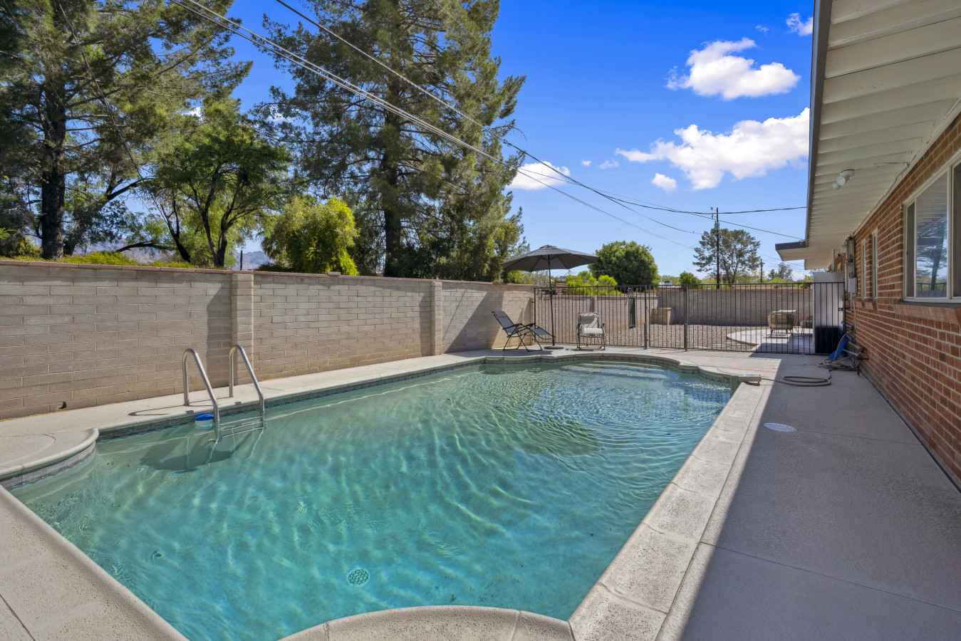 Sparkling private pool framed by desert landscaping, perfect for cooling off under sunny skies.