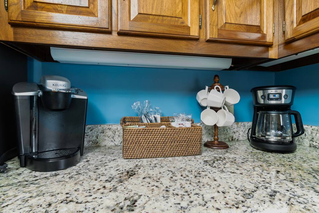 The kitchen offers both a drip coffee maker and a Keurig machine, providing guests with versatile brewing options for a perfect cup of coffee.