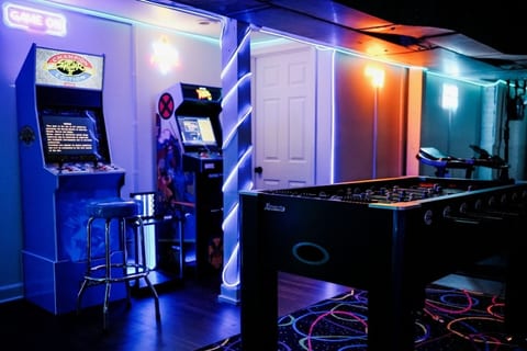 A vibrant, retro-style space buzzing with energy—perfect for friendly competition and late-night fun. The glowing lights and arcade charm make it a favorite hangout for guests of all ages.
