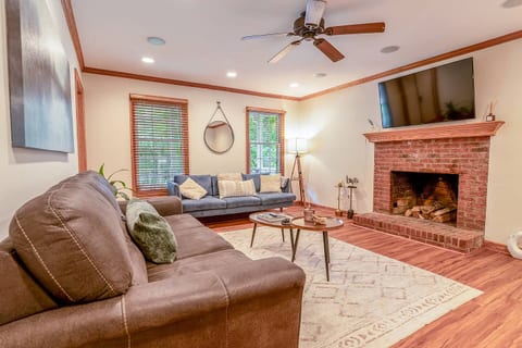 Unwind in our inviting living room, featuring a warm fireplace perfect for relaxing evenings. Enjoy your favorite shows or movies on the large smart TV, surrounded by comfortable seating and tasteful décor.