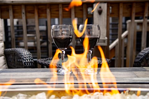 Cozy fire table patio with wine—perfect for relaxing evening nights