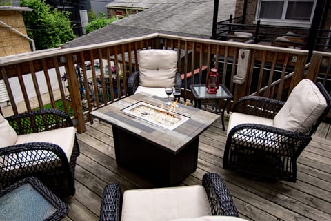 Cozy private deck with cushioned seating and a stylish fire table