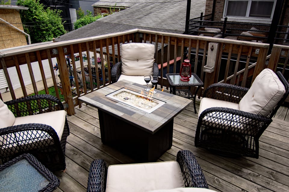 Cozy private deck with cushioned seating and a stylish fire table