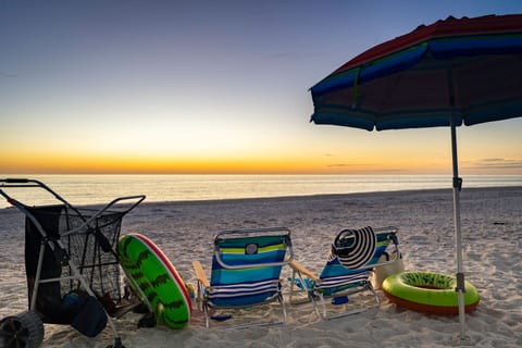 Relax in Paradise: Stunning Beachfront View with Cozy Chairs and Essential Beach Gear