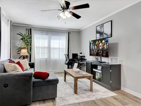Cozy living space with Smart TV, sofa bed, blackout curtains, and relaxing decor