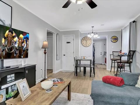 Cozy living space with Smart TV, sofa bed, blackout curtains, and relaxing decor
