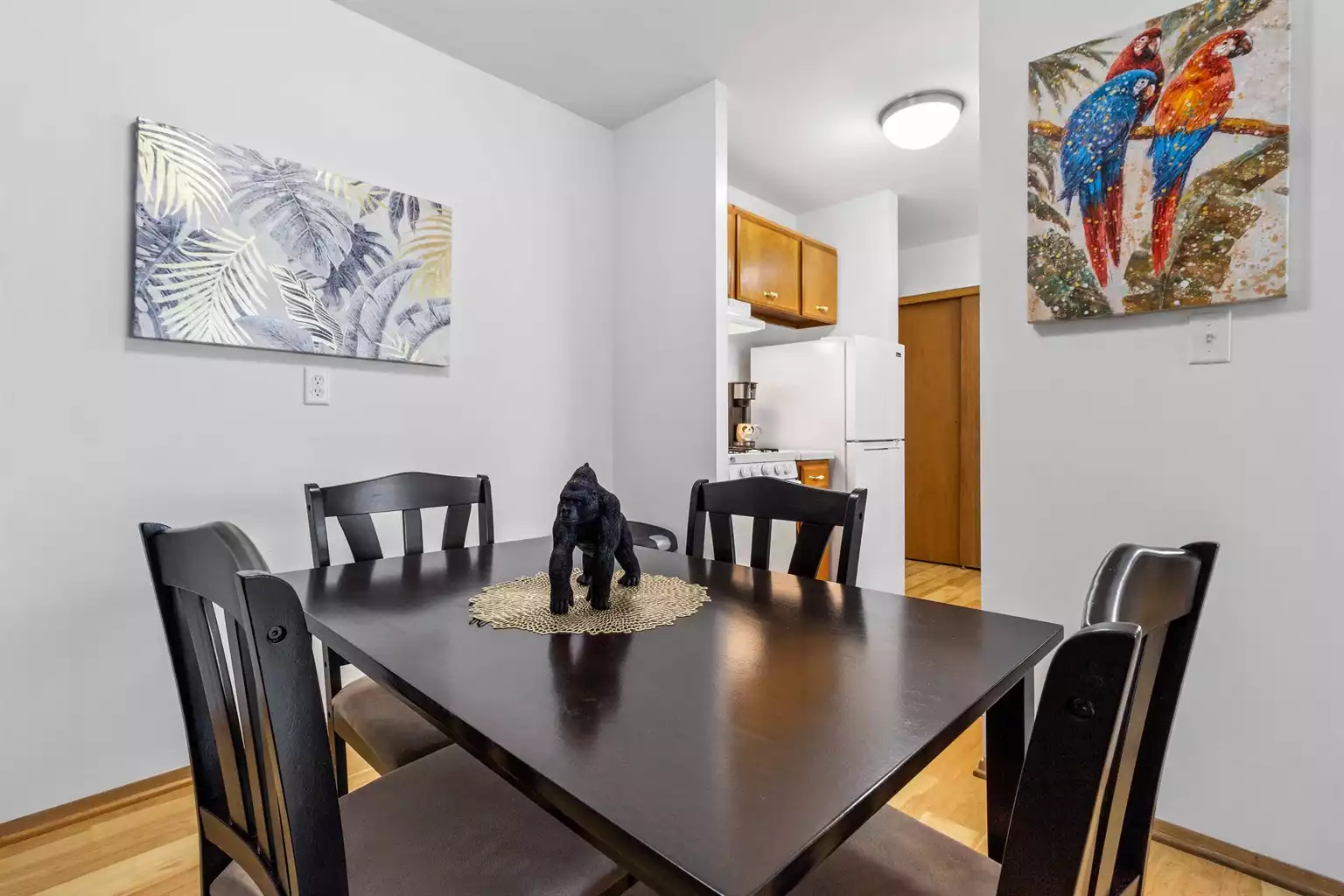 Full size dining table and plenty of storage space in kitchen cabinets.