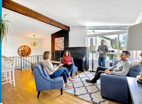 Spacious living area with stunning lake view and large windows for natural light.