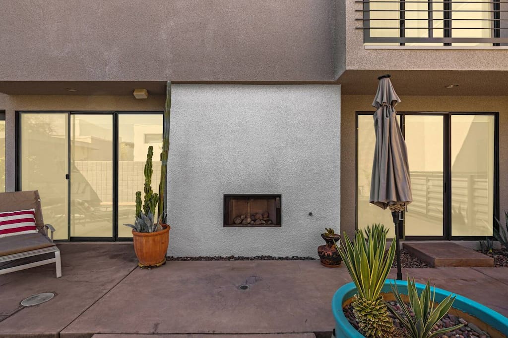 Cozy up by the outdoor fireplace next to the pool! This inviting spot features comfortable seating, perfect for evening chats or a nightcap. Enjoy the warm glow and tranquil ambiance as you relax under the stars—your perfect retreat awaits!