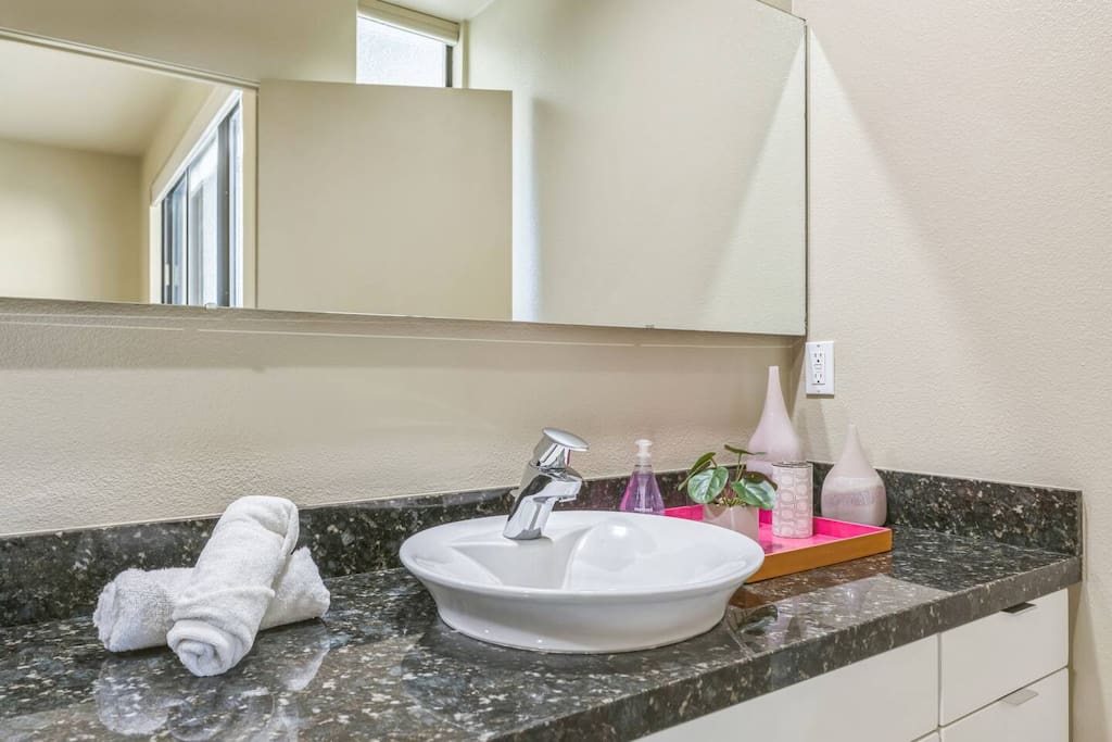 Introducing the convenient third bathroom! With modern fixtures and a bright, open vibe, it’s ideal for guests. Enjoy spaciousness, stylish decor, and all the essentials for a refreshing shower or a quick touch-up during your stay!