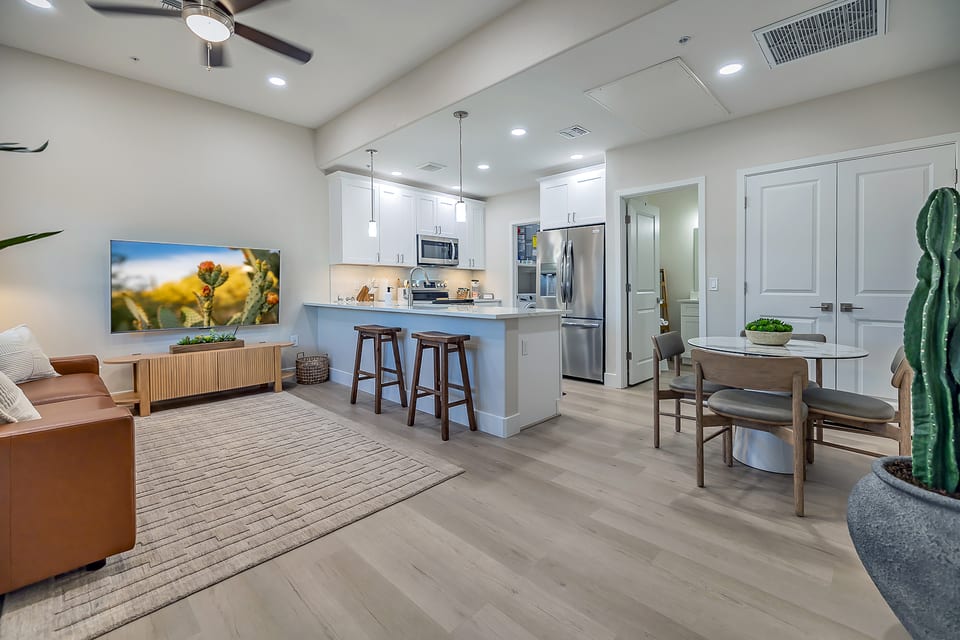Bright and spacious living and dining area with high ceilings, creating an open and airy atmosphere perfect for relaxation and entertaining.