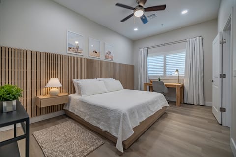 Spacious bedroom featuring a luxurious king bed, a dedicated workspace with a desk and chair, and stunning views of the Catalina Mountains. Ideal for both relaxation and productivity! Enjoy the perfect blend of comfort and convenience during your stay!