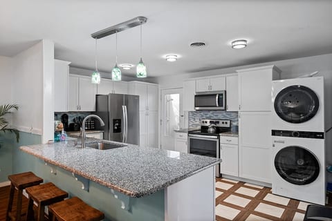 Kitchen with counter and stools