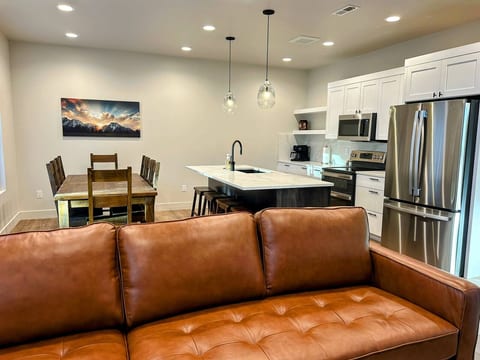 This open-concept main space welcomes you with a bright living room, dining area, and modern kitchen all flowing from the main entryway. It’s a comfortable, family-friendly layout that makes settling in easy after a day on the mountain.