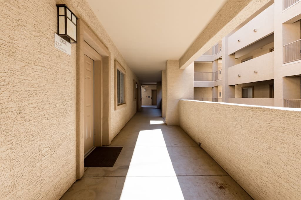 Outside entryway with elevator at the end of the hall.