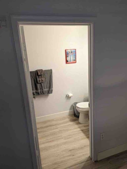 Small Bathroom with queen size bed with shower.