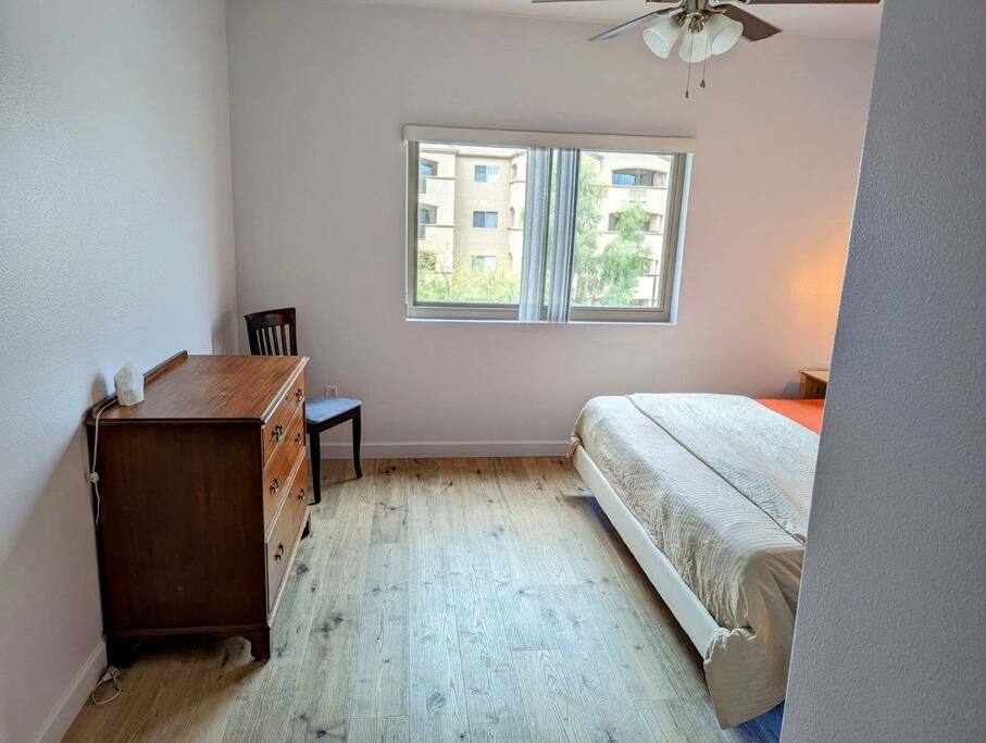 King bed in master bedroom with hardwood floors.