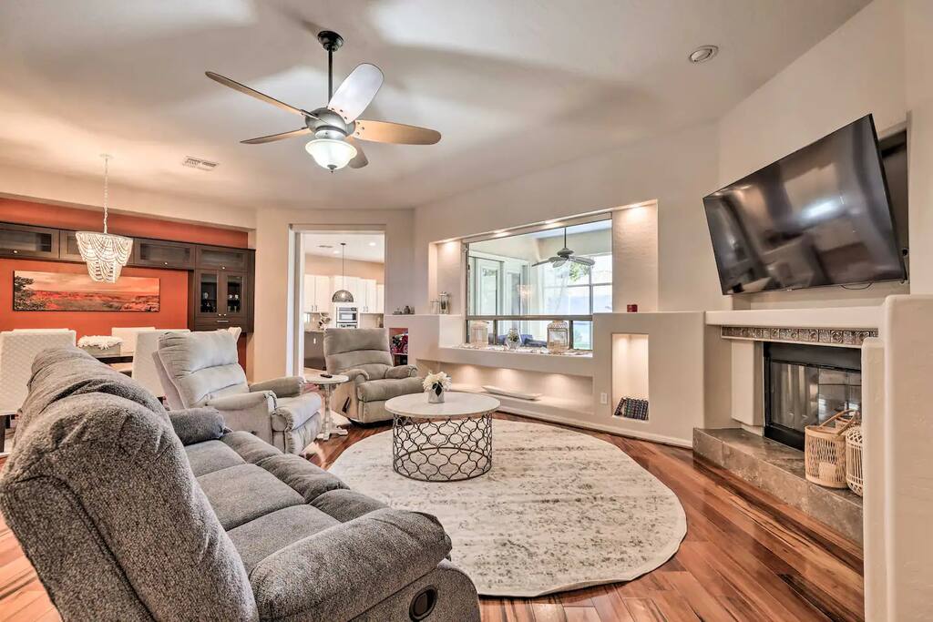 Large open spaced living room with fire place and TV