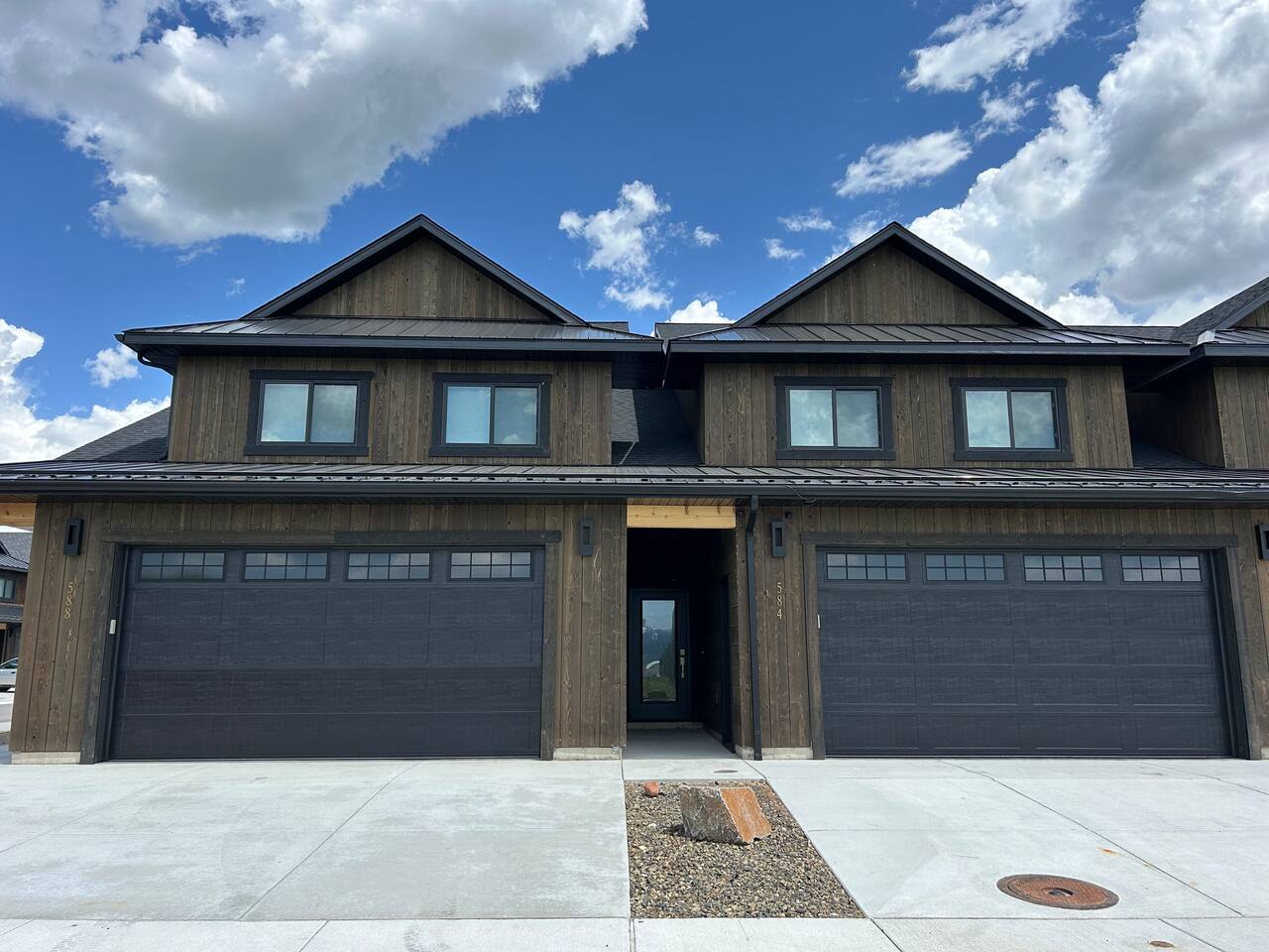  The front of these two units features two garages, providing secure parking and easy access. Each garage adds convenience and practicality, making it simple to store vehicles, gear, or outdoor essentials during your stay.