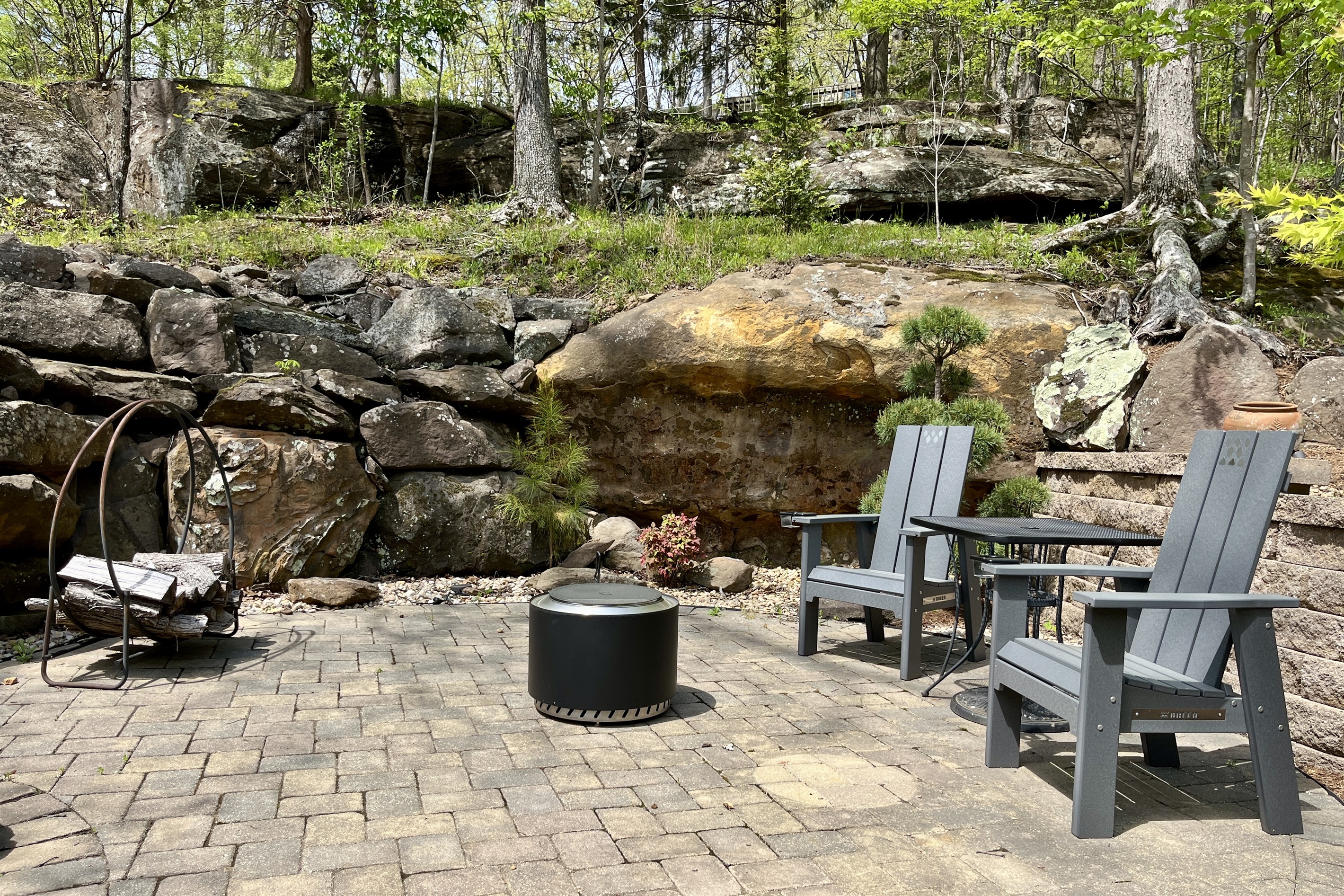 Smokeless firepit surrounded by natural rock and landscape