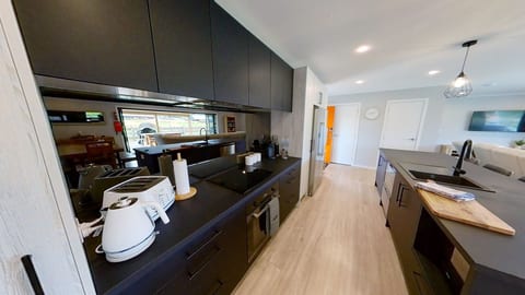 Sleek modern kitchen with island, ample prep space, and open-plan flow