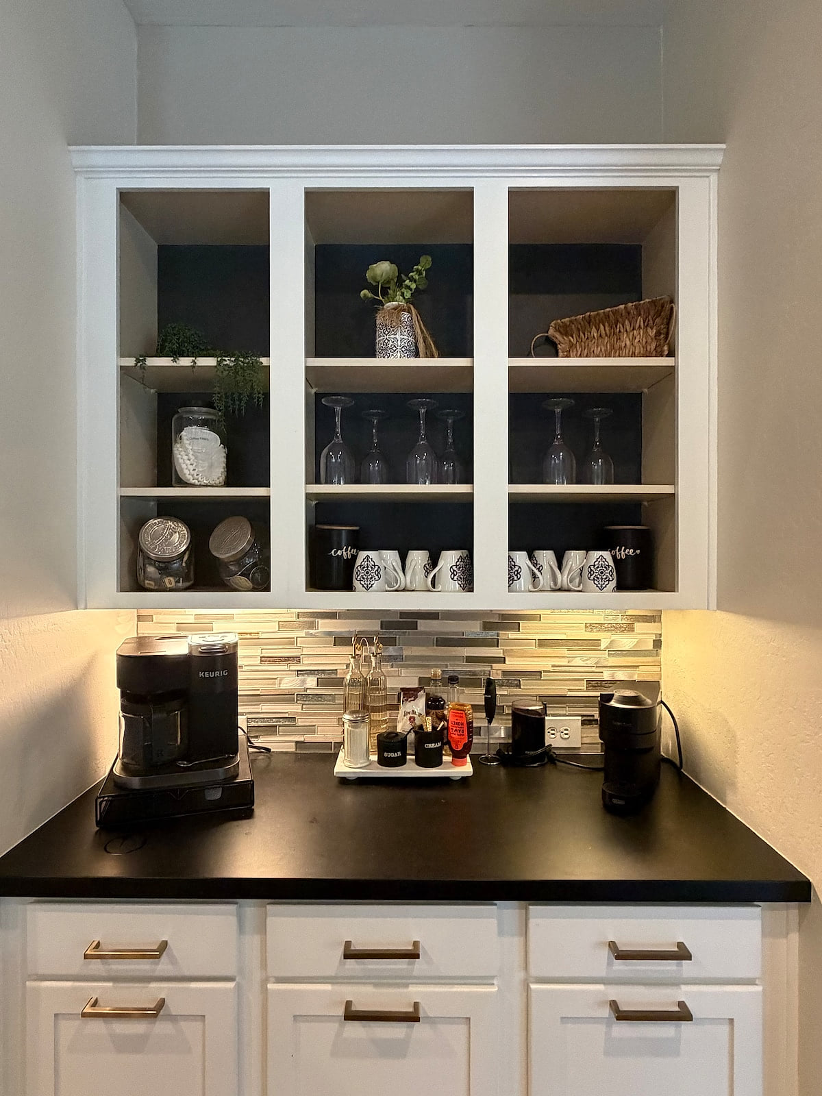 Curated coffee bar: cappuccino maker, Keurig, drip pot + coffee, tea & sweeteners.