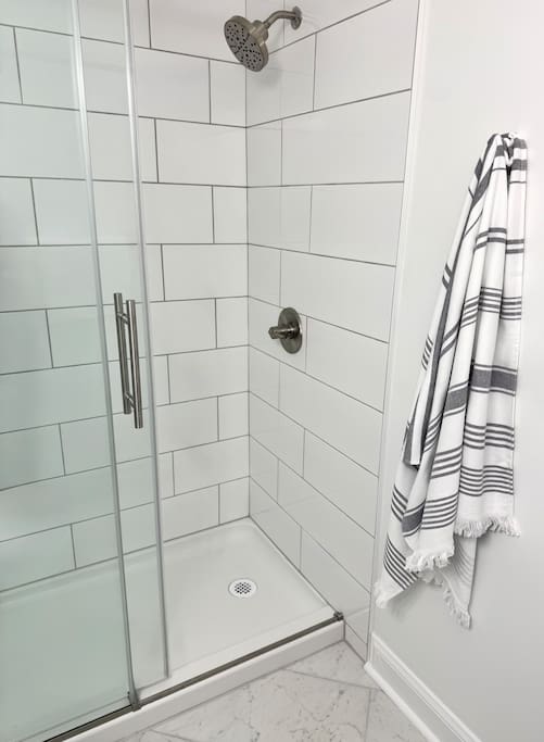 Walk-in shower with tiled walls and rainfall-style showerhead—simple, functional, and clean. Walk-in shower with tiled walls and rainfall-style showerhead—simple, functional, and clean. - Peaceful & Convenient 2BR Near Ballantyne - Charlotte