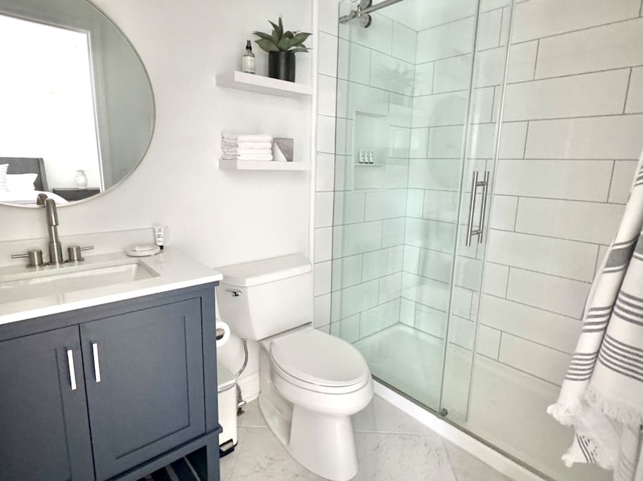 Spacious layout with glass walk-in shower and open shelving stocked with essentials. Spacious layout with glass walk-in shower and open shelving stocked with essentials. - Peaceful & Convenient 2BR Near Ballantyne - Charlotte
