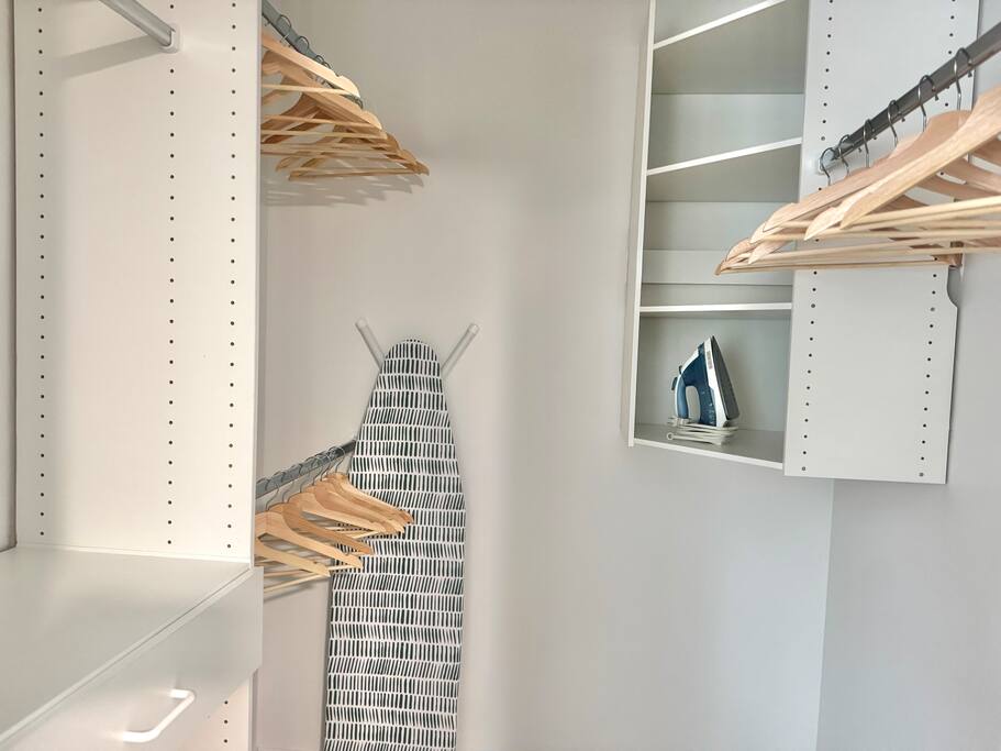 Generous walk-in closet with shelving, hangers, iron and ironing board for longer stays or business trips. Generous walk-in closet with shelving, hangers, iron and ironing board for longer stays or business trips. - Peaceful & Convenient 2BR Near Ballantyne - Charlotte