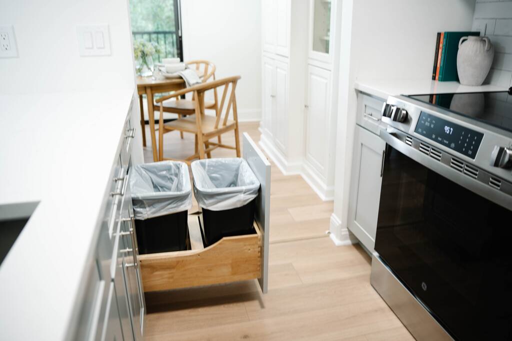 Built-in trash and recycling bins make cleanup easy and efficient. Built-in trash and recycling bins make cleanup easy and efficient. - Peaceful & Convenient 2BR Near Ballantyne - Charlotte