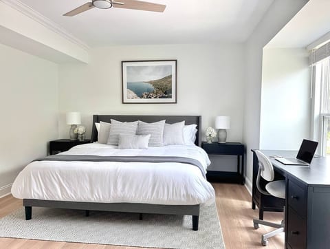 Spacious bedroom with a king bed, natural light and a desk setup—great for work or extended stays.