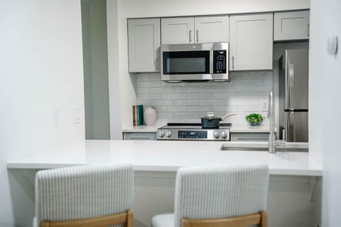 Convenient bar seating connects the kitchen to the living space—ideal for meals or remote work.