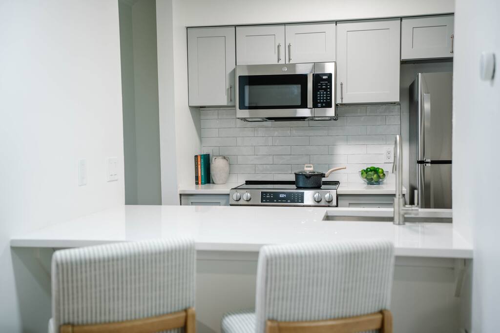 Convenient bar seating connects the kitchen to the living space—ideal for meals or remote work. Convenient bar seating connects the kitchen to the living space—ideal for meals or remote work. - Peaceful & Convenient 2BR Near Ballantyne - Charlotte