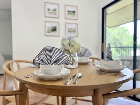 Round dining table with modern dishware and natural light—perfect for casual meals or working from home.