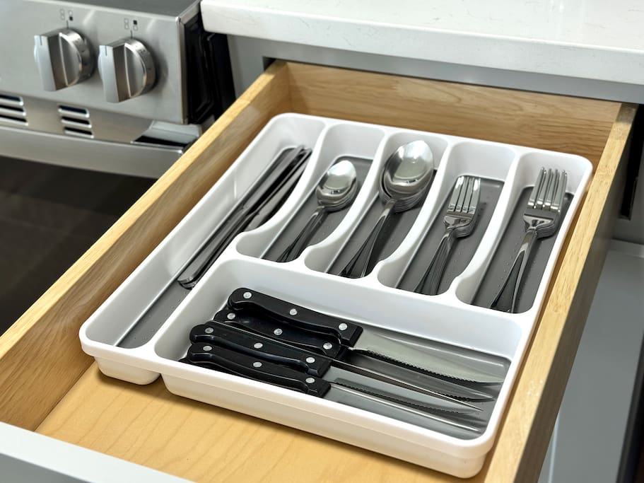 Kitchen essentials organized and ready—knives, forks, spoons, and more. Kitchen essentials organized and ready—knives, forks, spoons, and more. - Peaceful & Convenient 2BR Near Ballantyne - Charlotte
