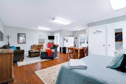 Studio layout with bed, living area, and kitchen with full-size appliances