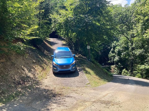 Driveway. There is Flat parking at the top of the driveway for two cars or to enable you to turn around, or park along driveway utilizing parking brake.